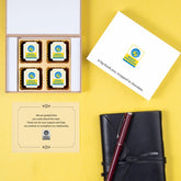 Open MDF box showing assorted logo chocolates for event guests