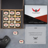 Branded black wooden chocolate box with dealership logo and chocolates