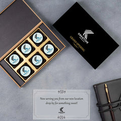 Angled shot of 6‑piece logo chocolate box used as inauguration gift