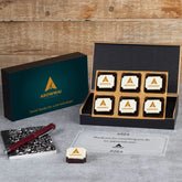 Open MDF box revealing six logo chocolates and thank‑you note for employees.