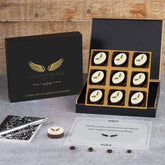 Open black luxury gift box with Golden Wings logo and nine custom printed chocolates—perfect premium client thank‑you.
