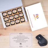 Top view of 12‑piece branded chocolate box presented for office opening