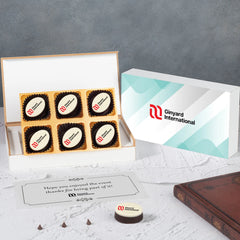 White gift box of four logo chocolates with company branding for corporate event