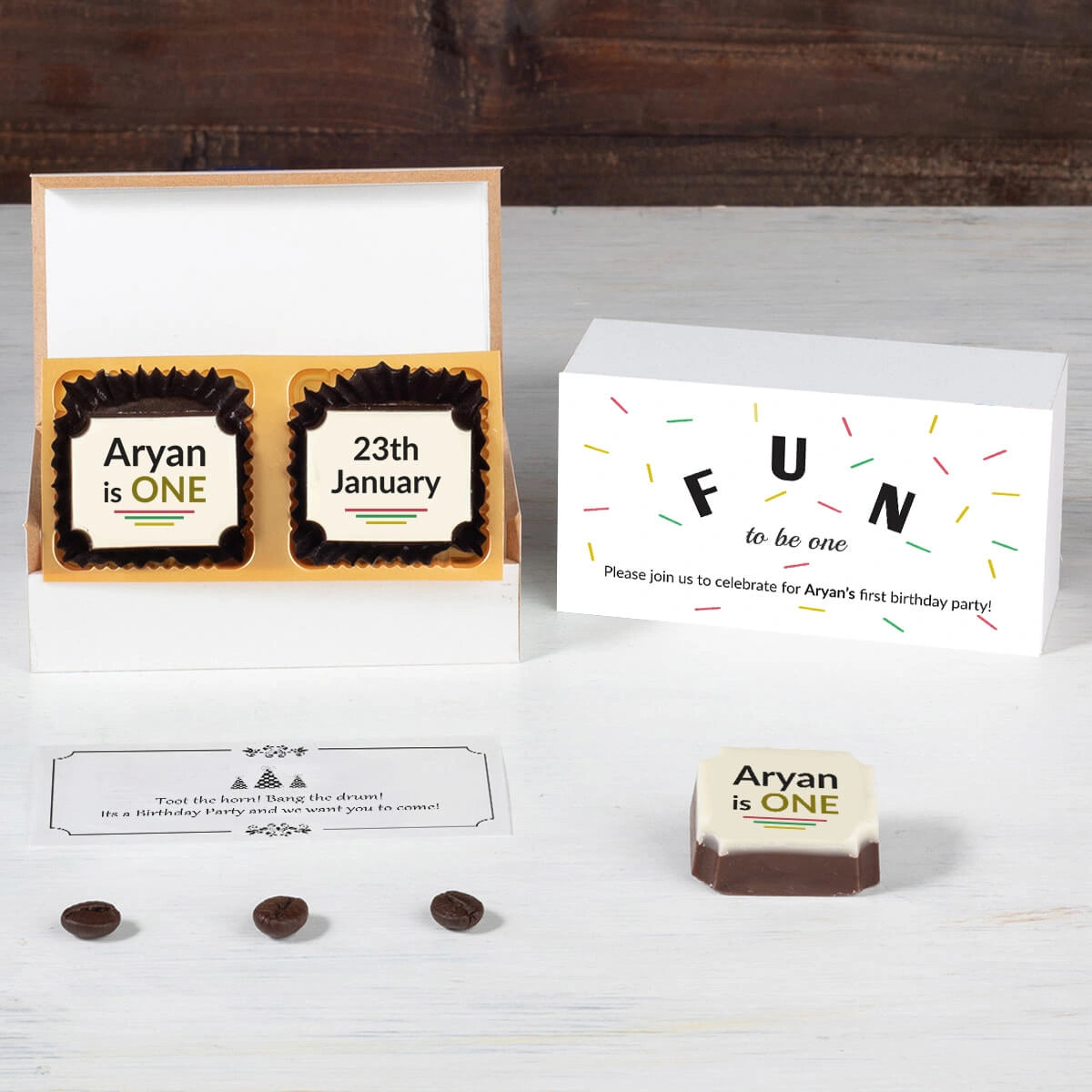 Open 2-chocolate box showing printed chocolates for 1st birthday invitation card sample