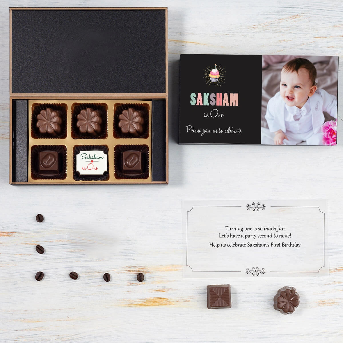 Open box showcasing birthday invitation card 1st chocolate print
