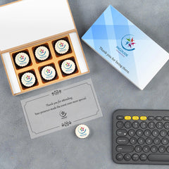 White wooden gift box filled with printed chocolates for attendees