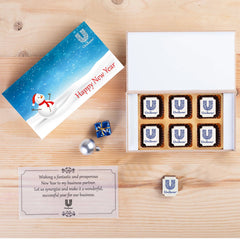 Open wooden gift box with custom‑printed logo chocolates and personalized greeting inside lid.