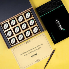 Close‑up of 12‑piece personalised chocolate box for factory inauguration guests