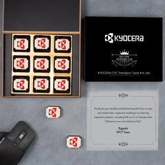 Elegant 12‑piece wooden box of logo chocolates celebrating a milestone company anniversary.