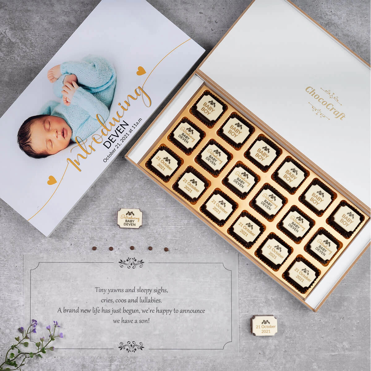Black wooden box with custom chocolates – stylish newborn gift option
