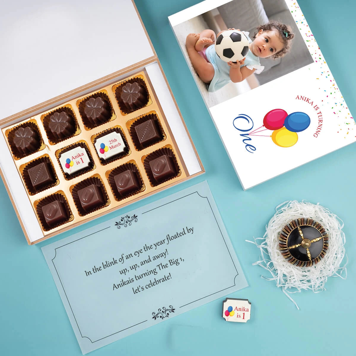 Open box displaying personalised first birthday invites chocolates