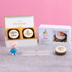 Open view of personalized chocolate box with printed chocolates for baby announcement