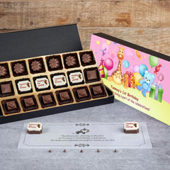 Open box showing personalized first birthday party favors chocolates