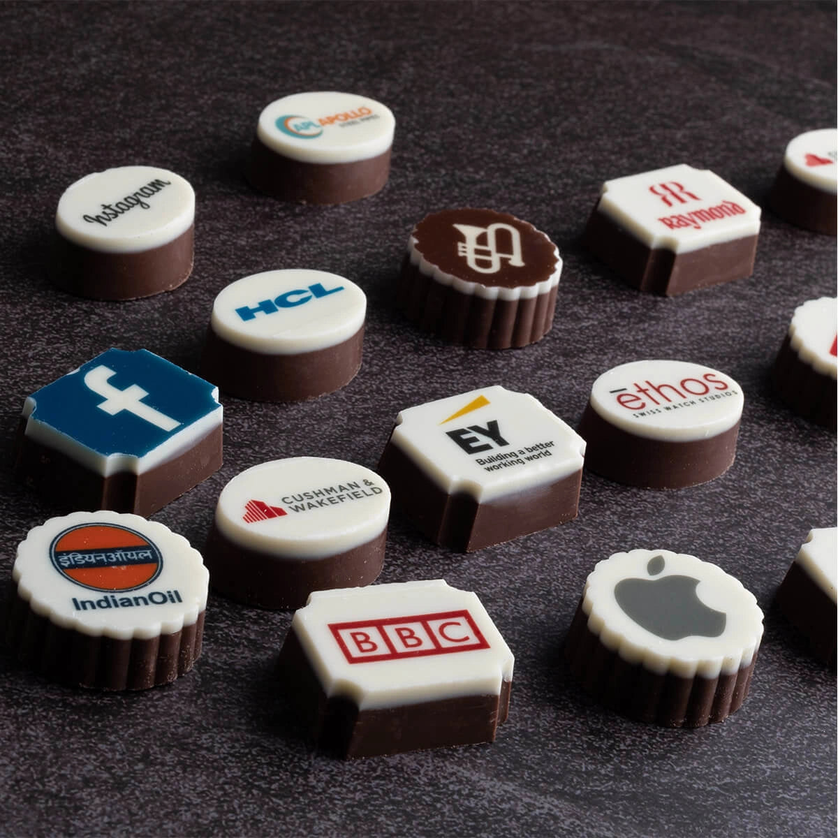 printed round, square and hexagon chocolates printed with global brand logos—luxury promotional treats for clients.