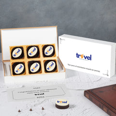 Open white wooden box showing mix of printed chocolates for retirement gift.