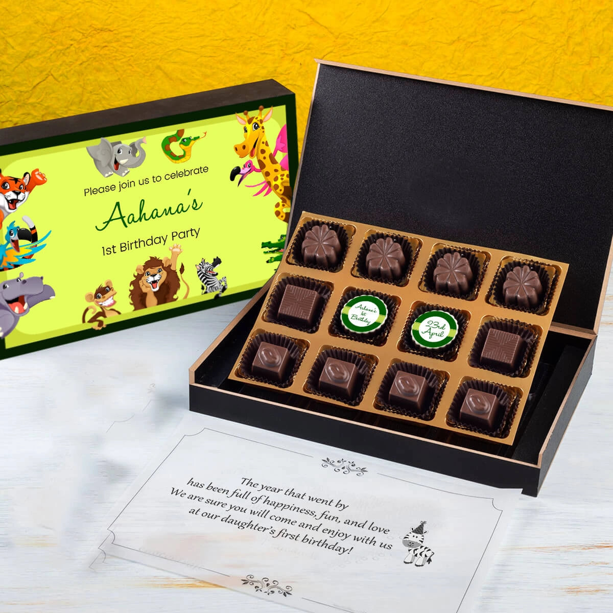 Open box showing unique 1st birthday invitation card chocolates