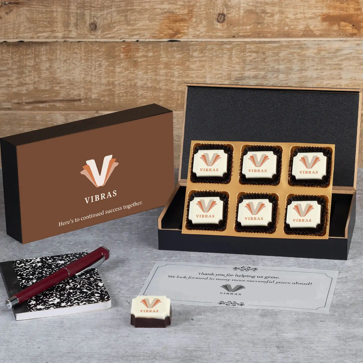 Wooden box with six logo chocolates for business partners