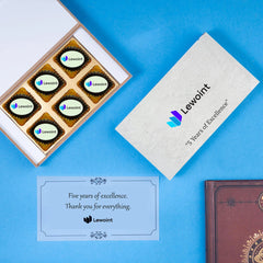 Oval white chocolate featuring edible corporate logo for personalised work anniversary celebrations