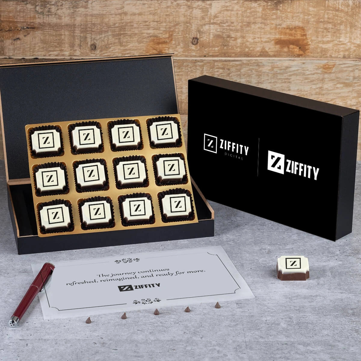Ziffity Digital rebrand gift – sleek black wooden box opened to show 12 square logo chocolates for company relaunch events. 